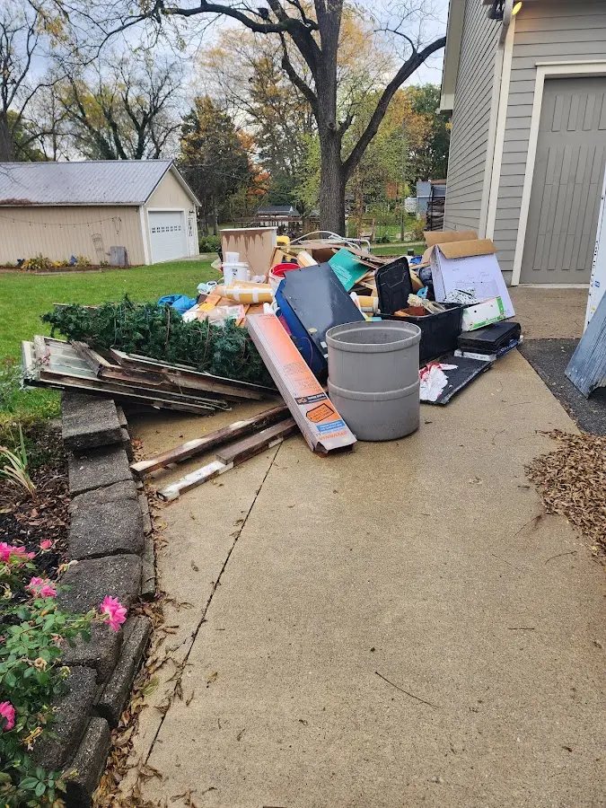 Dumpster being loaded with debris for Estate Cleanout Dumpster Rental in Superior
